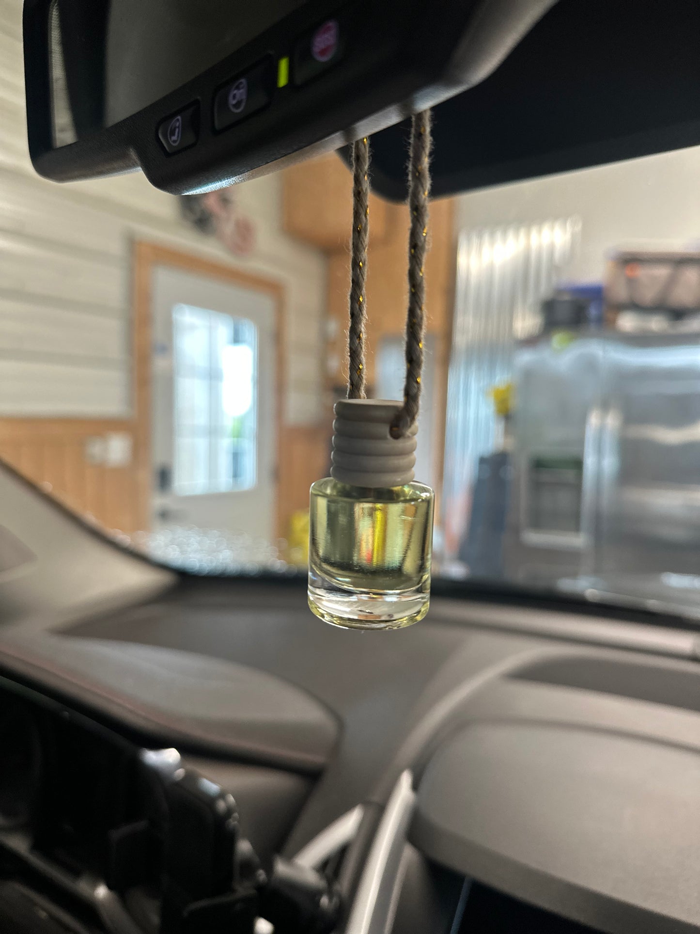 a glass bottle with a cord in a car