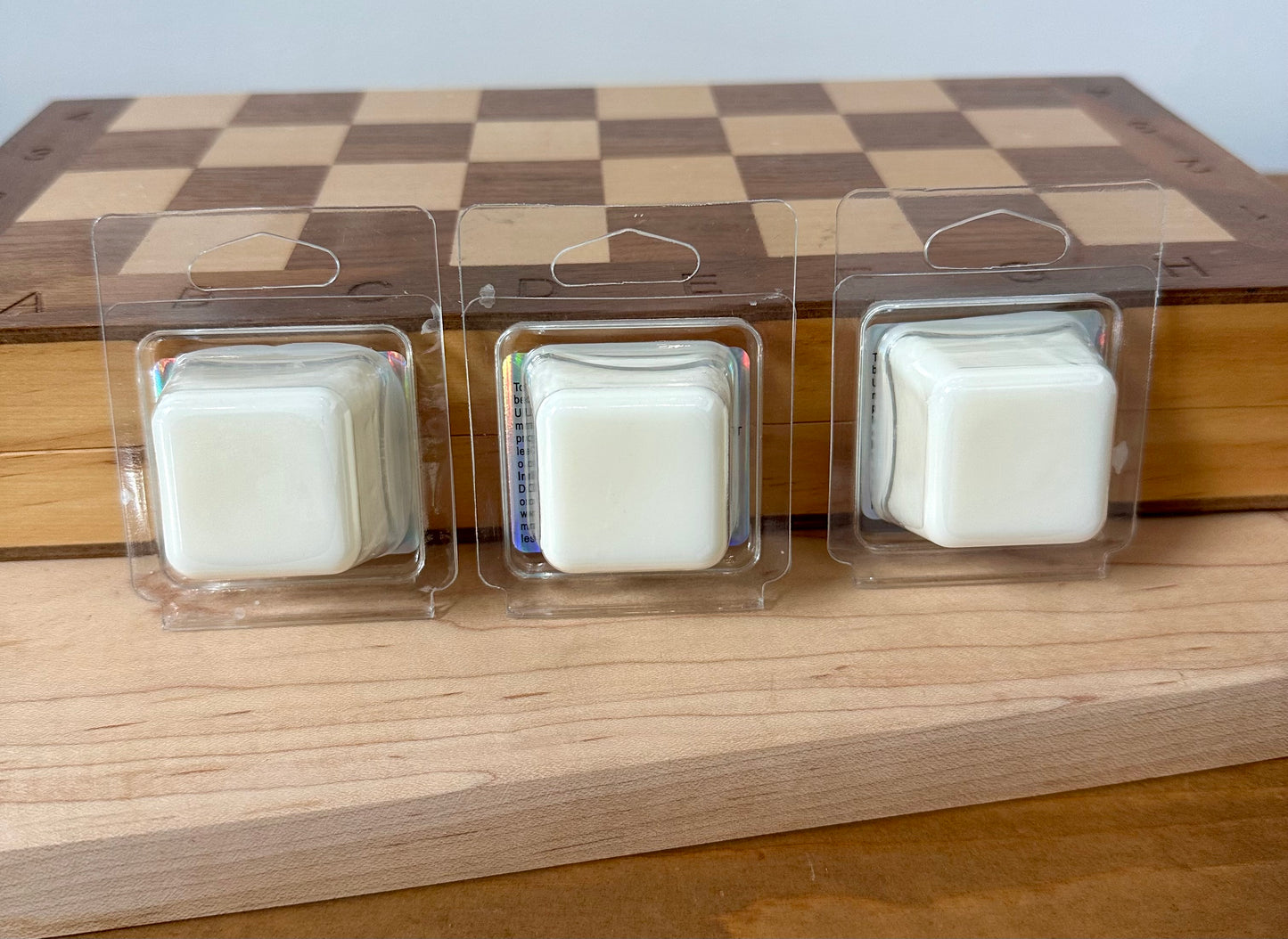 a couple of candles sitting on top of a wooden table
