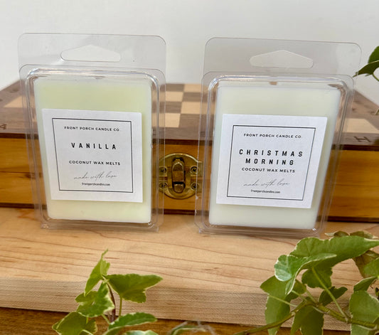 a couple of candles sitting on top of a wooden table