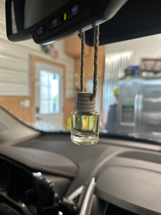 a glass bottle with a cord in a car