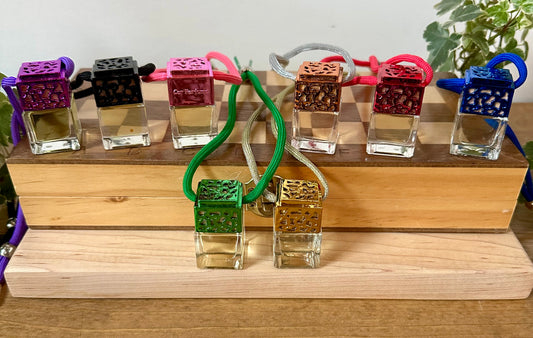 a couple of bottles of perfume sitting on top of a wooden box