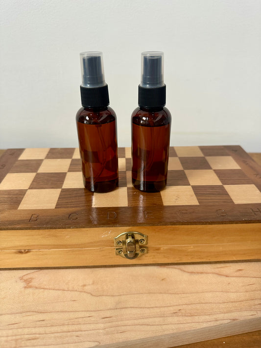 two brown bottles sitting on top of a wooden box