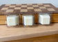 a couple of candles sitting on top of a wooden table