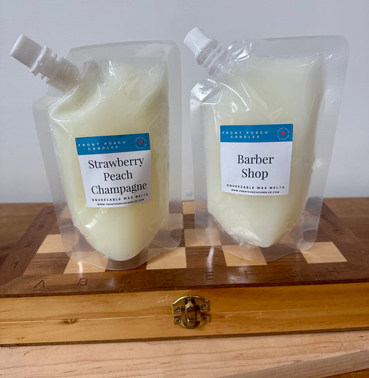 a couple of bottles of soap sitting on top of a wooden table